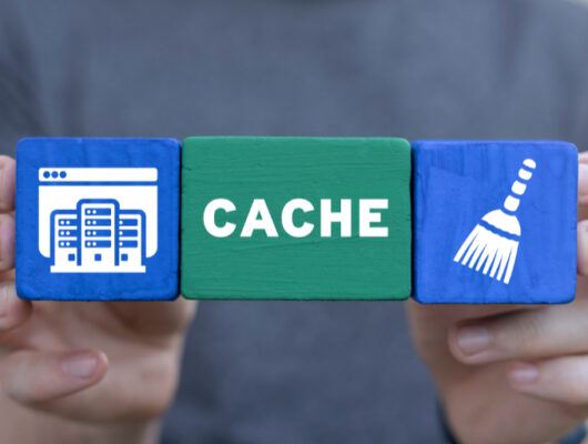 Man holding colorful blocks sees word: CACHE.