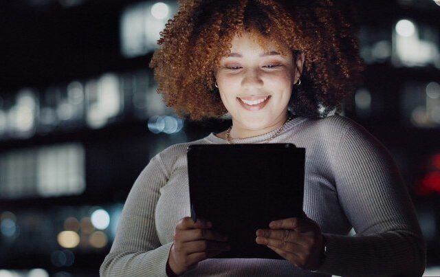 Tablet, night balcony and relaxed woman reading and smiling, customer experience or ecommerce