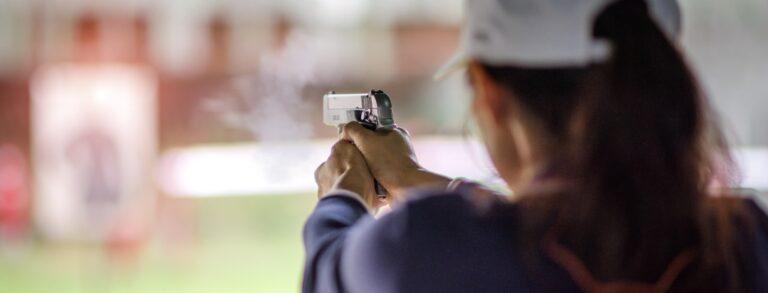 gun holding in hand of woman in practice shooting in martial arts for self defense in an emergency case