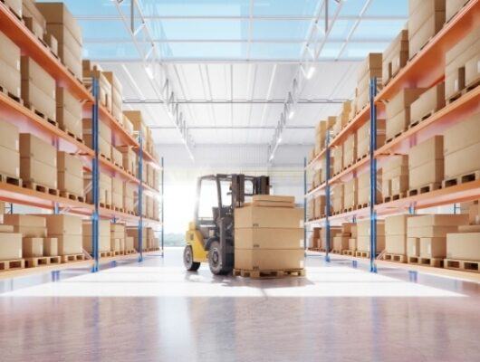 forklift in middle of warehouse with shelve of boxes