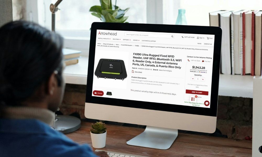 Man sitting at desk looking at Product page of Arrowheadphx.com on desktop computer