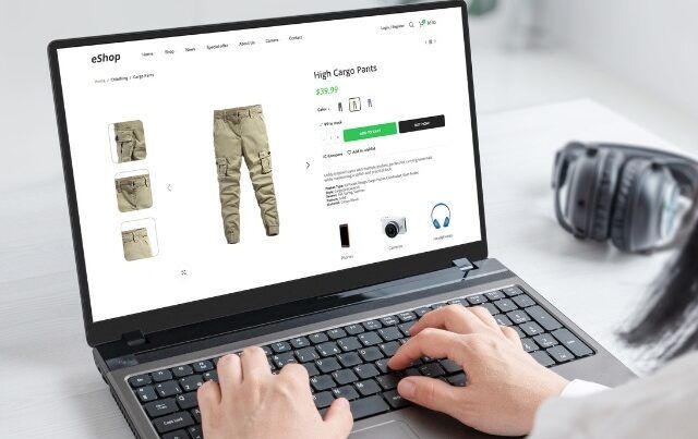 Person on laptop browsing online fashion store looking at cargo pants product page