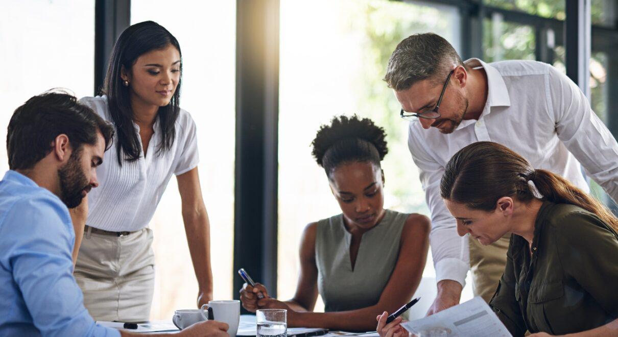 Group of executives around table working - BigCommerce Enterprise SEO