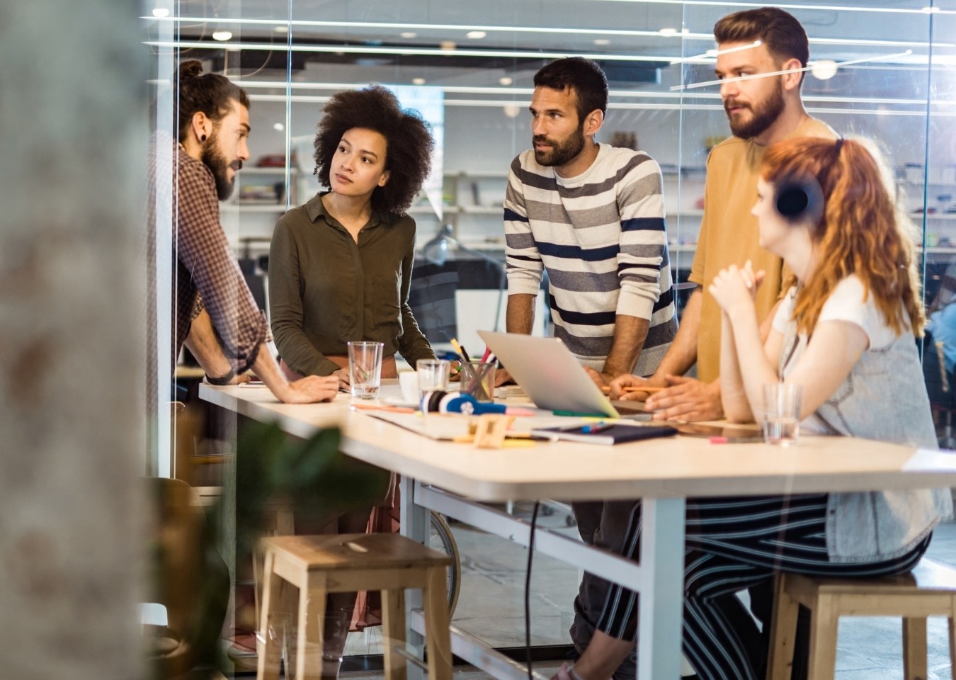 Business team standing around table - working together concept